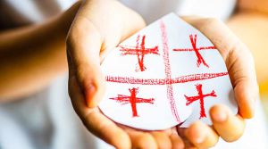 Kid hands with heart shaped flag